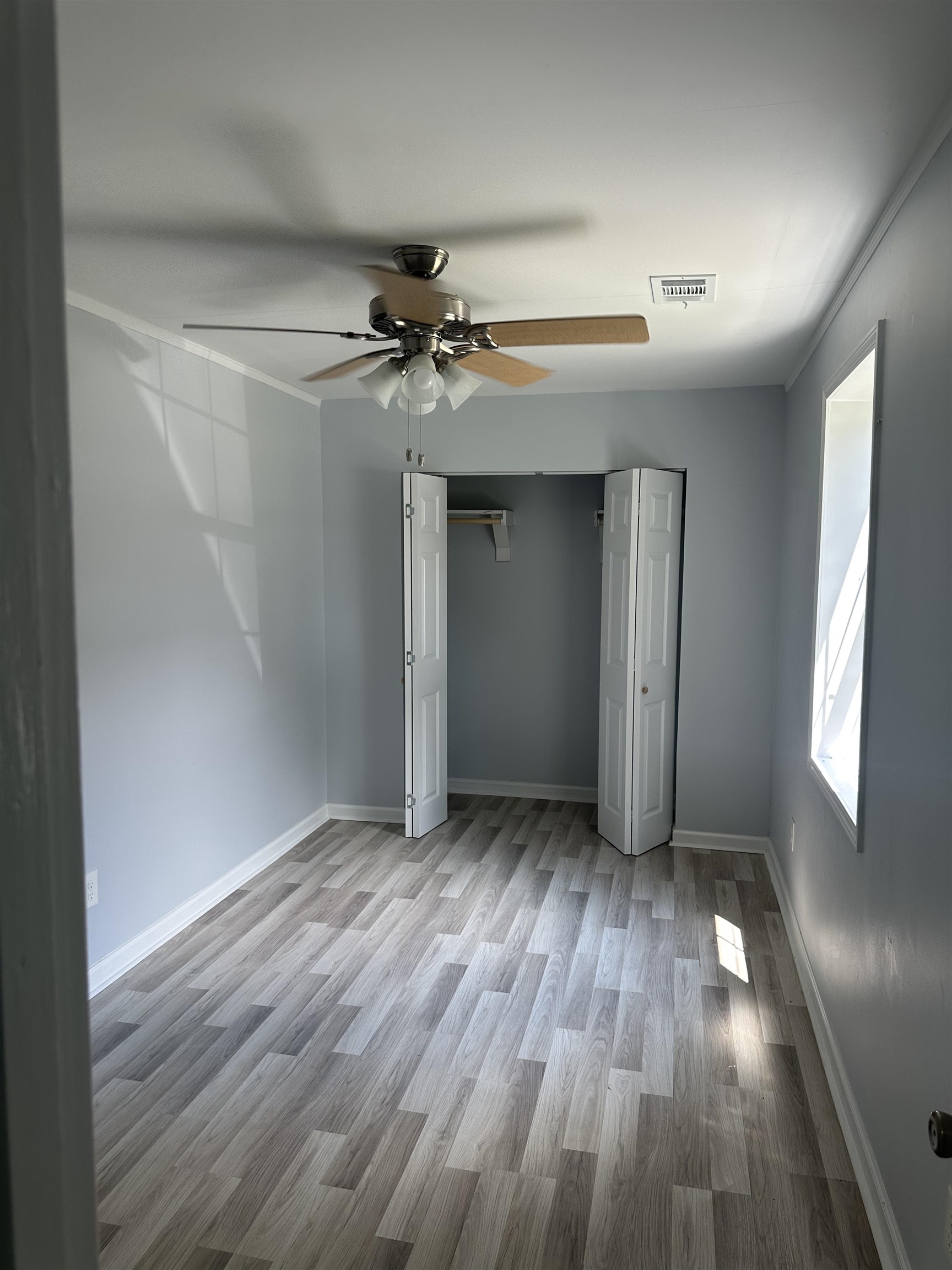 3402 Lakeview Road Memphis, TN 38116 - Photo 5 of 30 Unfurnished bedroom with wood finished floors, ceiling fan, and a closet