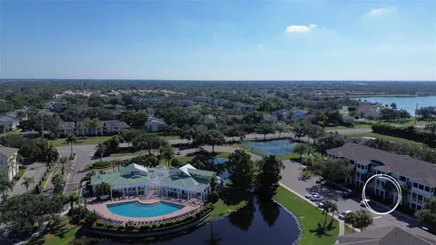 an aerial view of a house with a yard and lake view