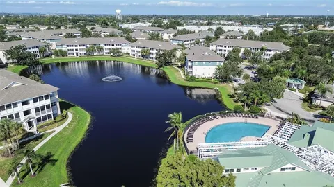 a view of a house with swimming pool and sitting area