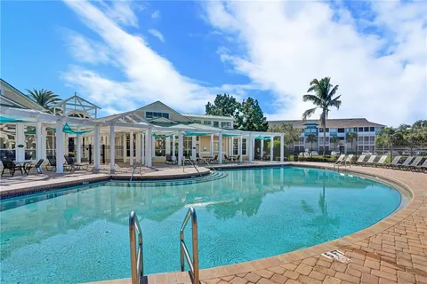a view of a house with swimming pool and a yard