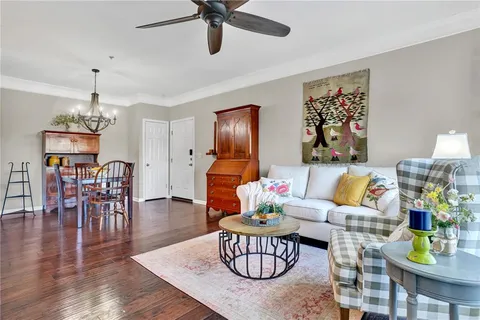 a living room with furniture and kitchen view
