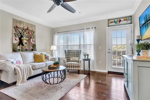 a living room with furniture and a potted plant