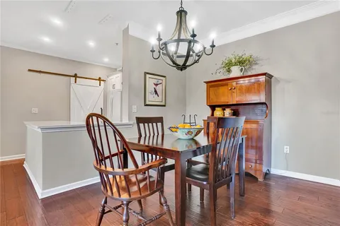 a view of a dining room with furniture wooden floor and chandelier
