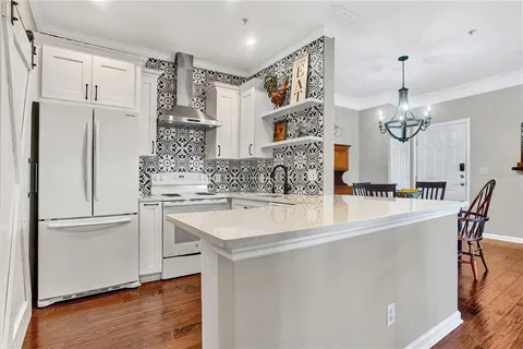 a kitchen with white cabinets and white appliances