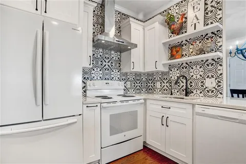 a view of a hallway with shelf and wooden floor