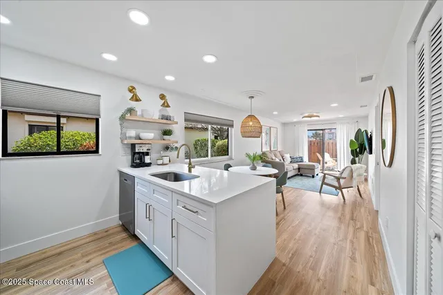 a kitchen with appliances a sink and cabinets