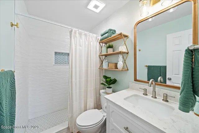 a dining room with furniture and potted plants
