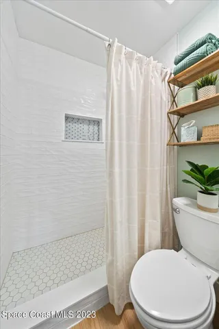 a bedroom with a bed and a chair