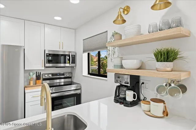 a dining room with furniture a chandelier and wooden floor