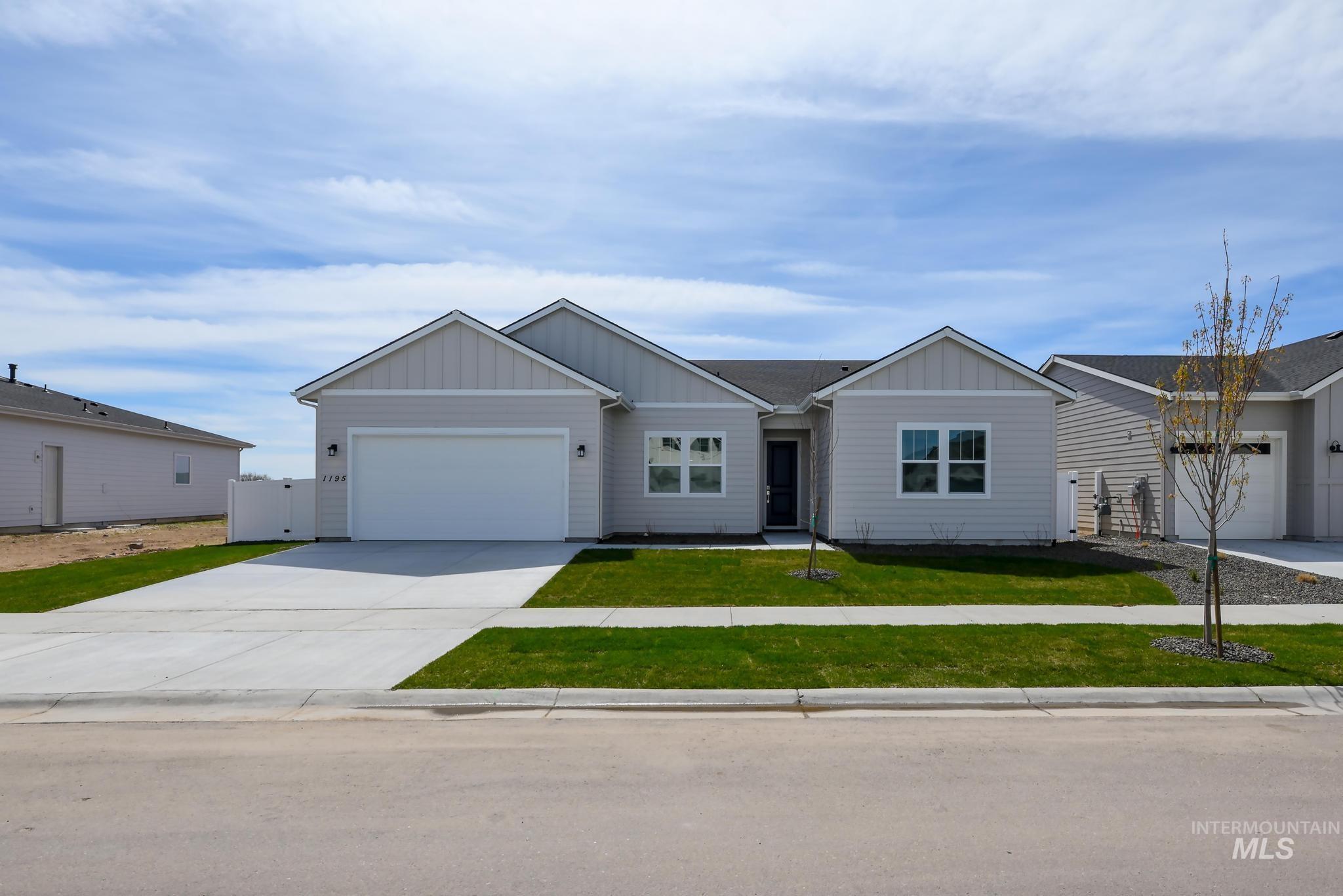 Single-story residence featuring light gray siding and complementary vertical accents