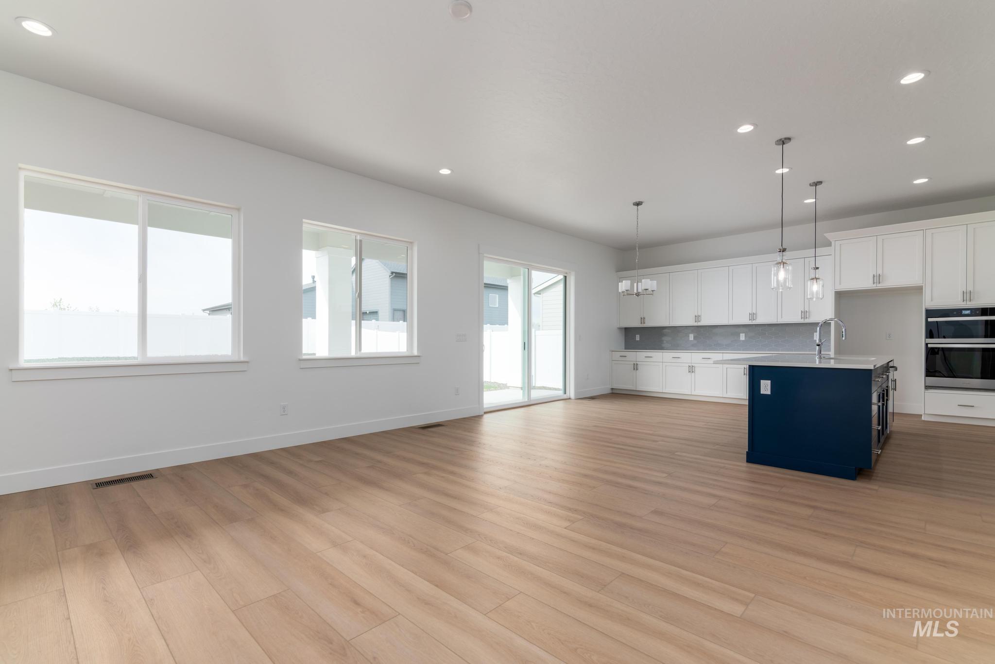 1195 West Switchgrass Drive Meridian, ID 83642 - Photo 3 of 22 Spacious open-concept living area featuring light wood-finish flooring and white walls