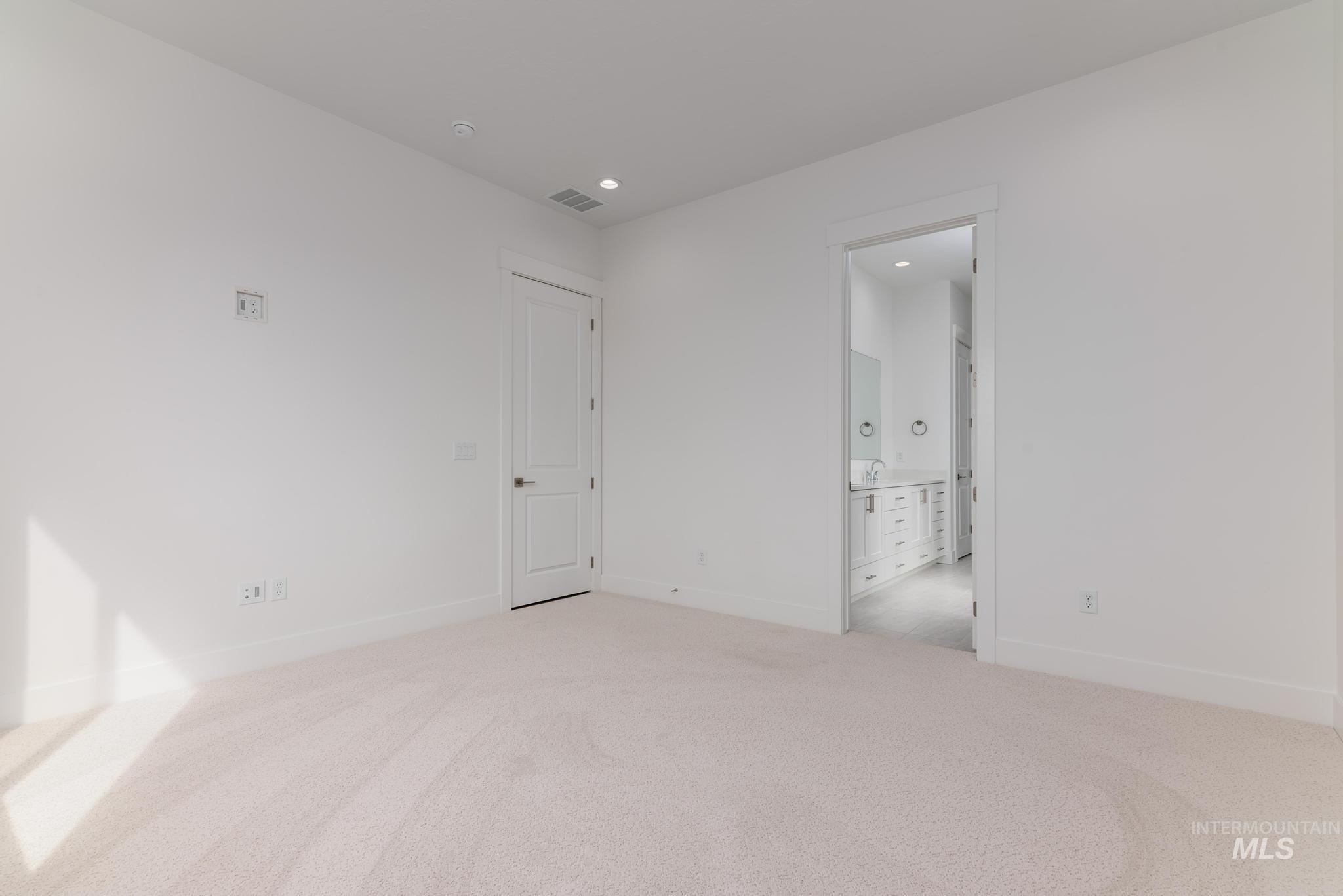 1195 West Switchgrass Drive Meridian, ID 83642 - Photo 7 of 22 Spacious interior room with light-toned carpeting and white walls