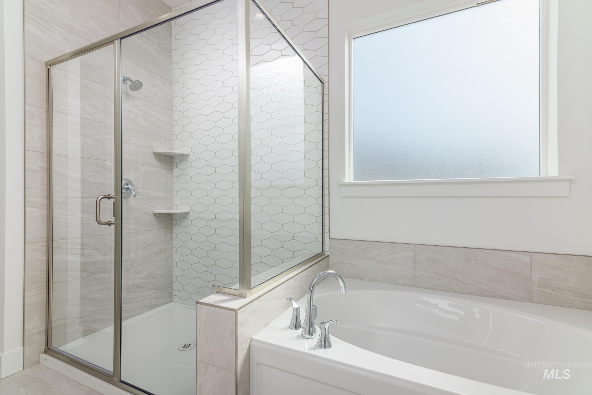 1195 West Switchgrass Drive Meridian, ID 83642 - Photo 9 of 22 Walk-in shower with clear glass enclosure and hexagon tile accent wall