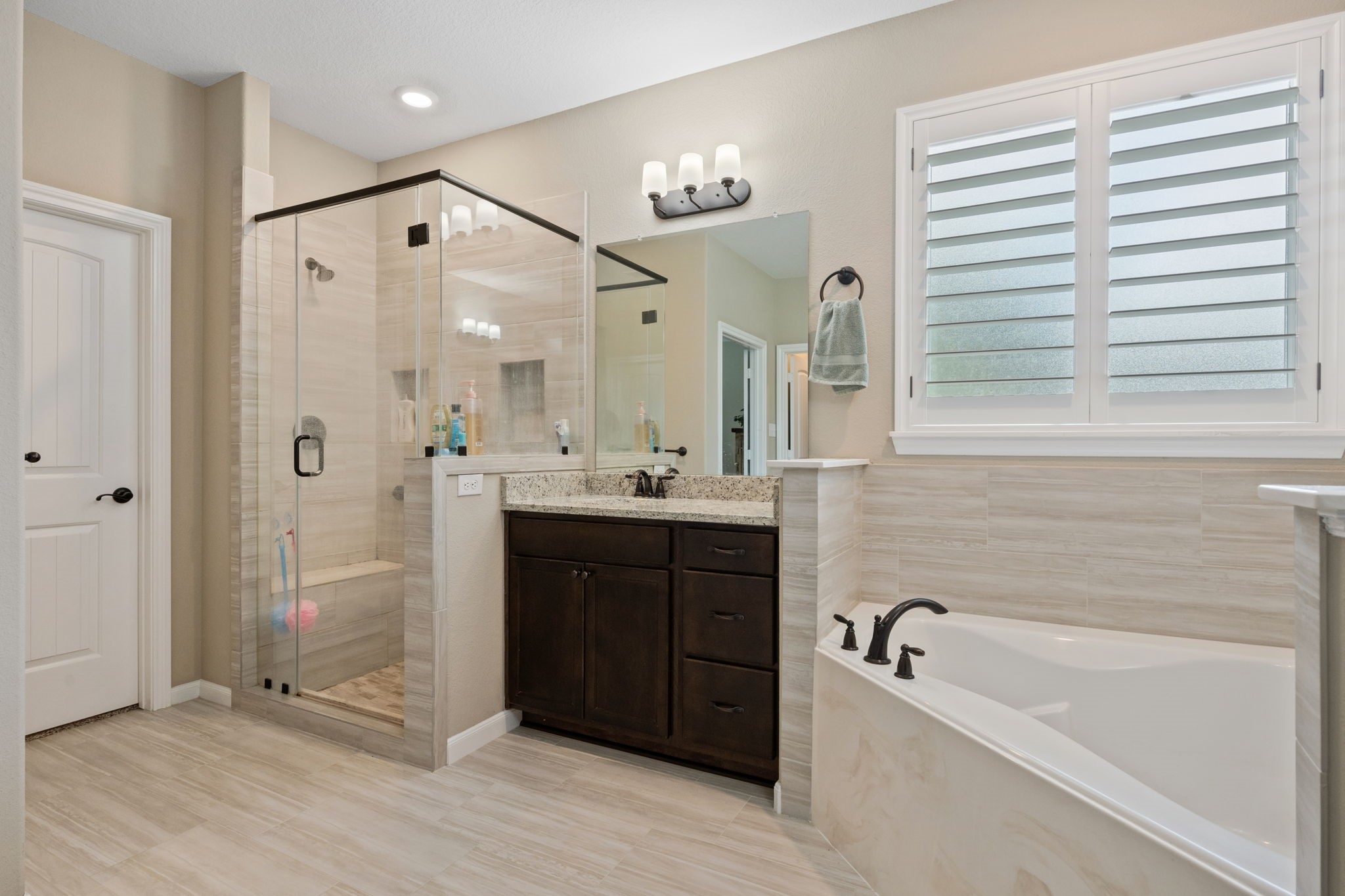 3004 Tyler Street Dayton, TX 77535 - Photo 20 of 34 a bathroom with a tub sink shower and mirror
