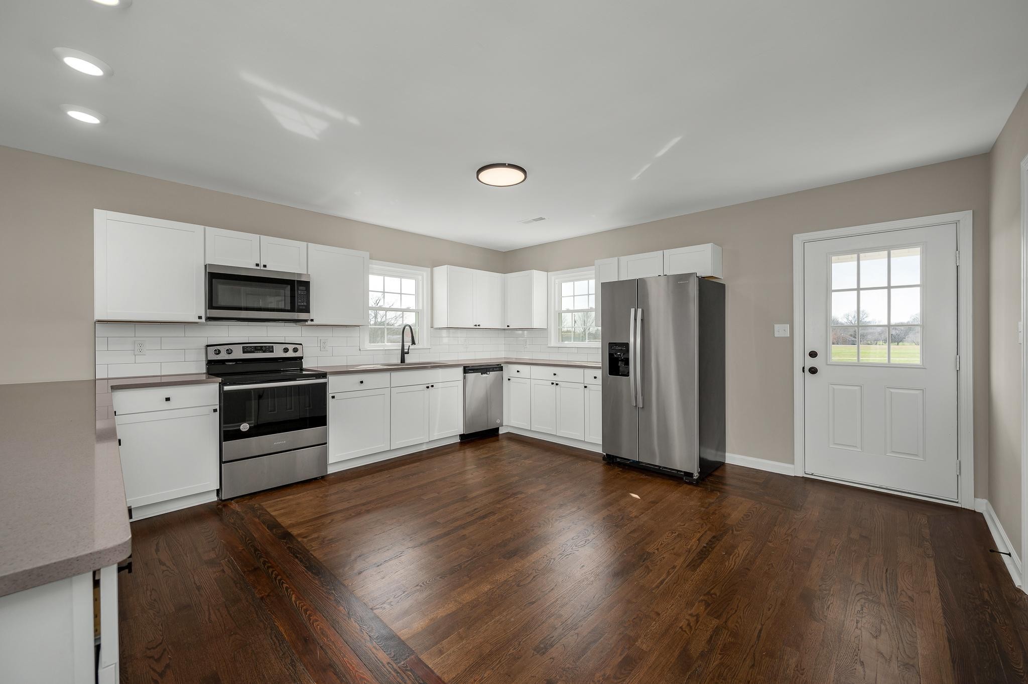 2771 Kinneys Road Cedar Hill, TN 37032 - Photo 11 of 45 a kitchen with granite countertop stainless steel appliances and wooden floor