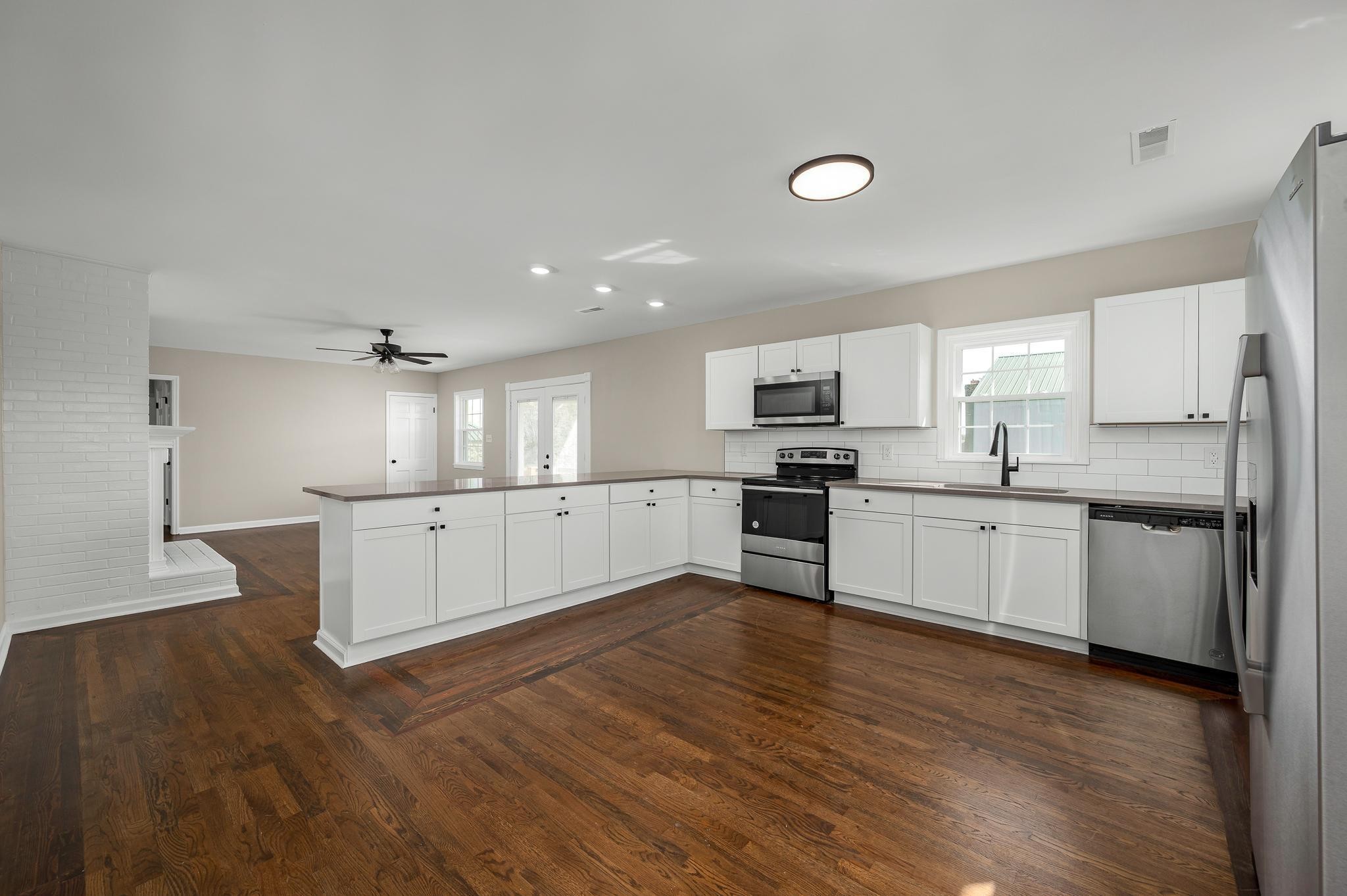 2771 Kinneys Road Cedar Hill, TN 37032 - Photo 12 of 45 a large kitchen with white cabinets stainless steel appliances