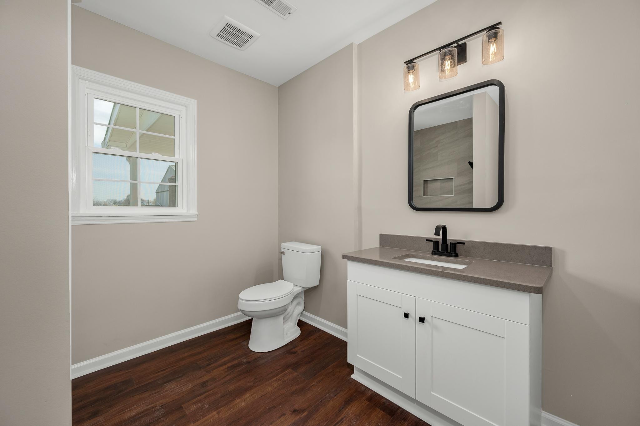 2771 Kinneys Road Cedar Hill, TN 37032 - Photo 24 of 45 a bathroom with a toilet sink and mirror