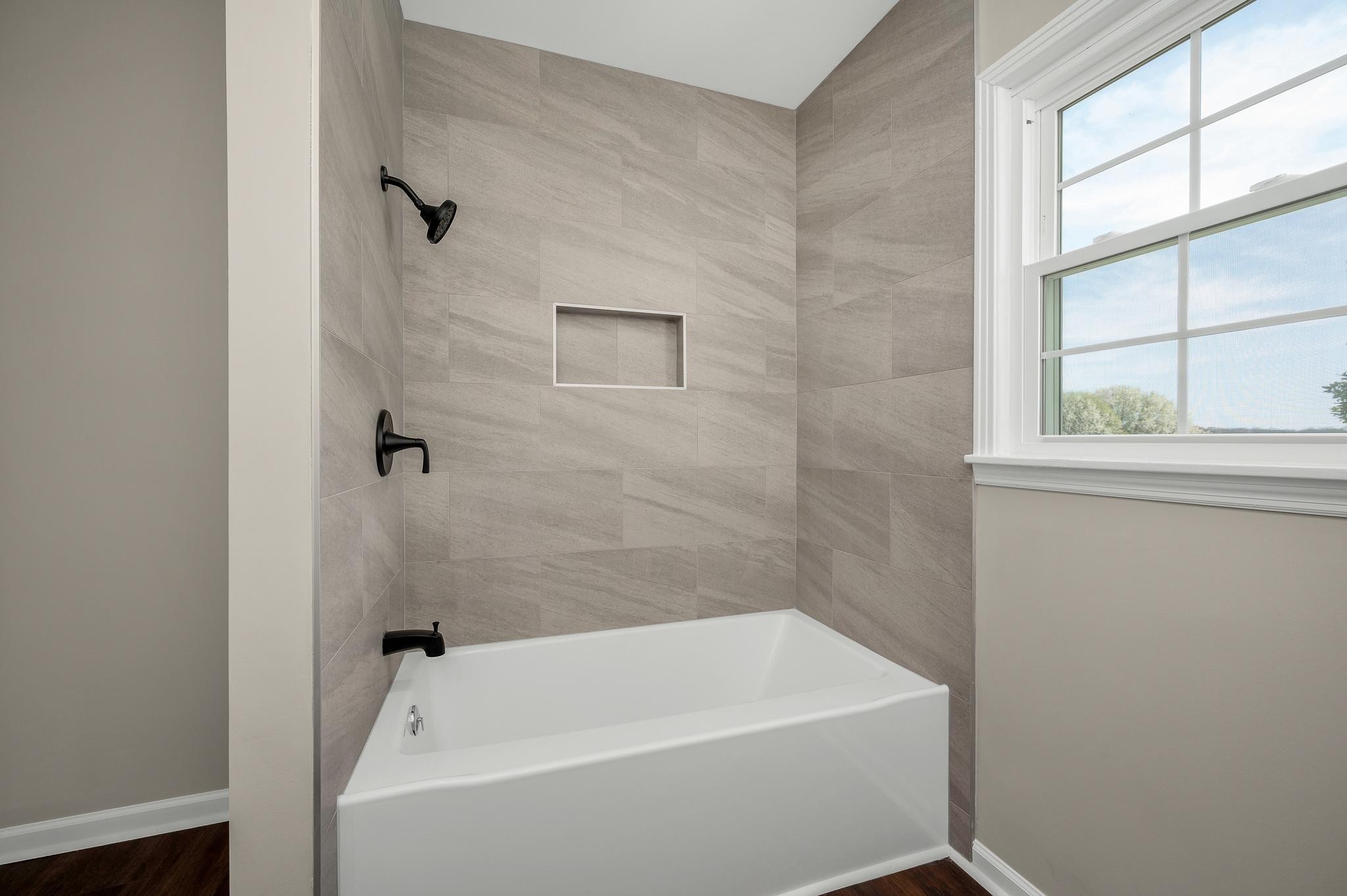 2771 Kinneys Road Cedar Hill, TN 37032 - Photo 25 of 45 a bathroom with a white bath tub and a shower