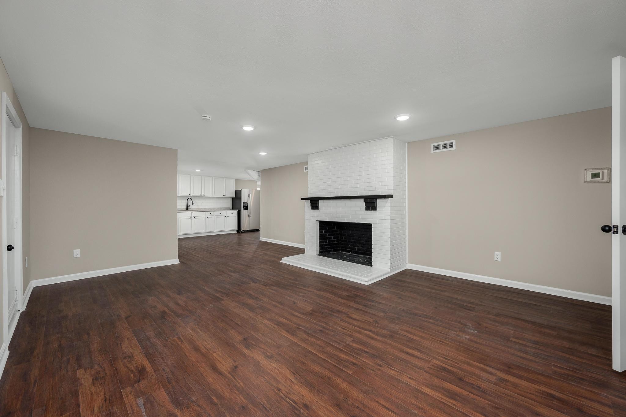 2771 Kinneys Road Cedar Hill, TN 37032 - Photo 27 of 45 a view of empty room with wooden floor and fireplace