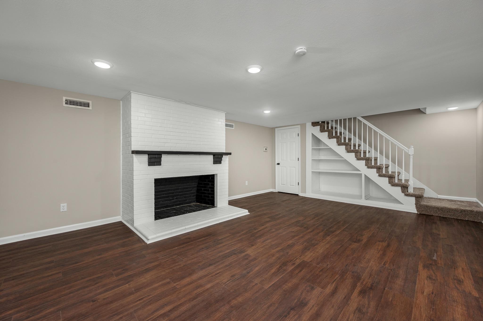 2771 Kinneys Road Cedar Hill, TN 37032 - Photo 28 of 45 a view of a livingroom with wooden floor and a fireplace
