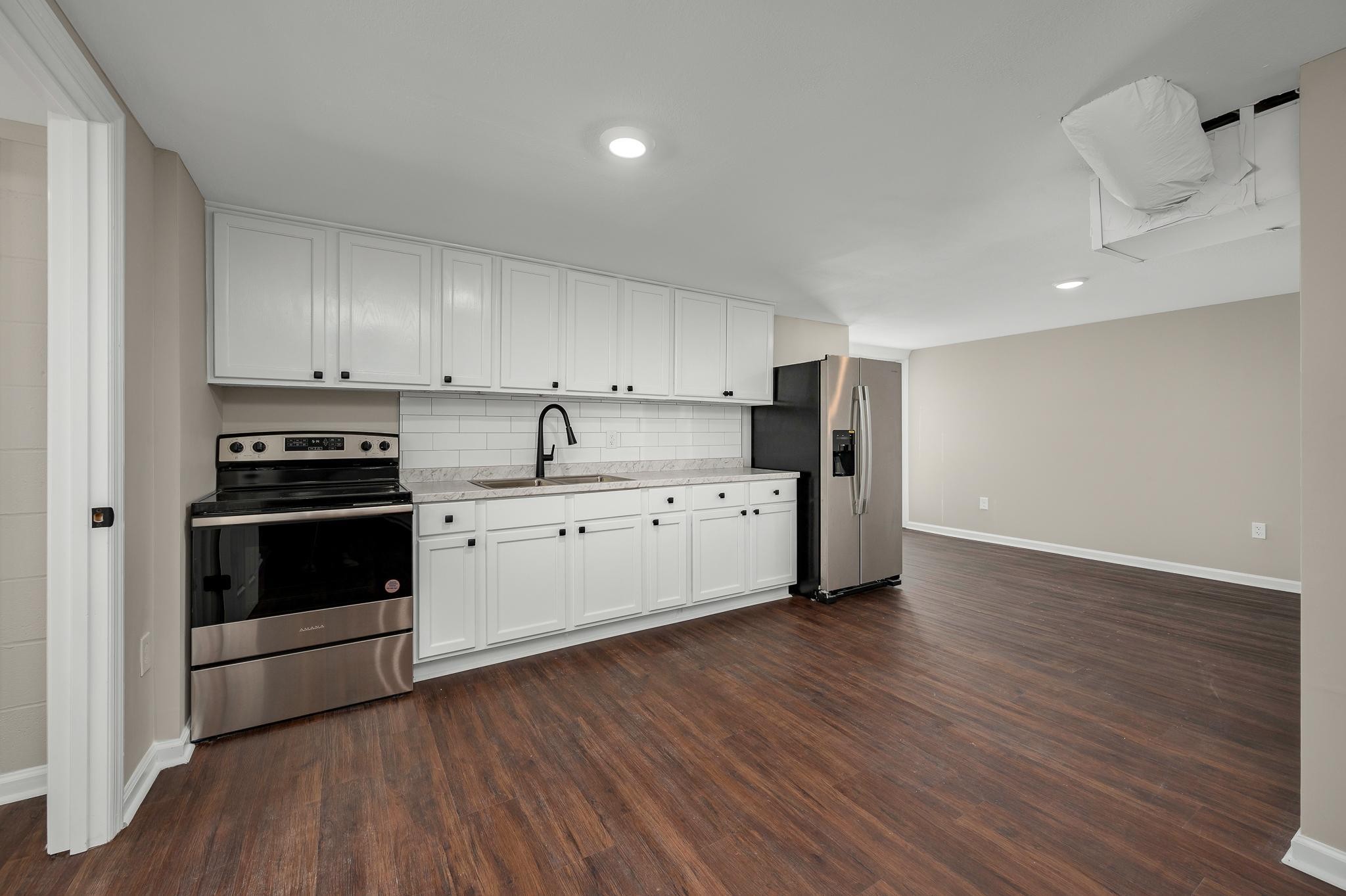 2771 Kinneys Road Cedar Hill, TN 37032 - Photo 30 of 45 a kitchen with stainless steel appliances a stove a sink and a refrigerator