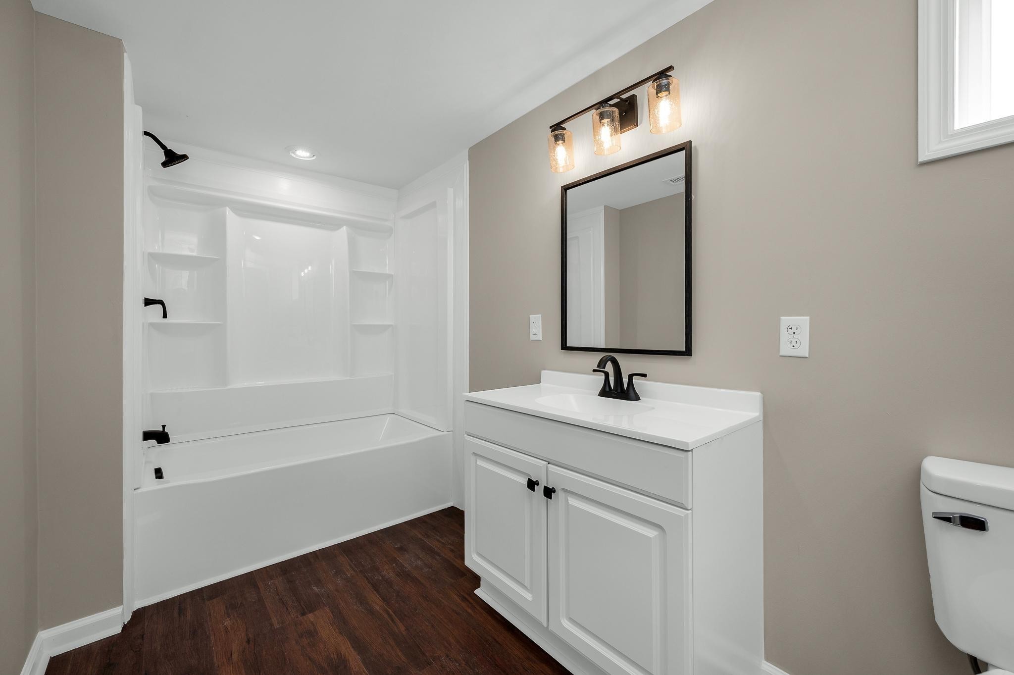 2771 Kinneys Road Cedar Hill, TN 37032 - Photo 32 of 45 a bathroom with a sink a toilet and shower