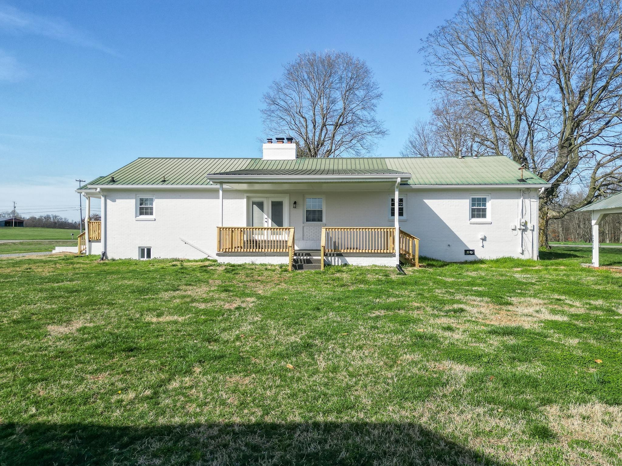 2771 Kinneys Road Cedar Hill, TN 37032 - Photo 41 of 45 a front view of a house with a garden and yard