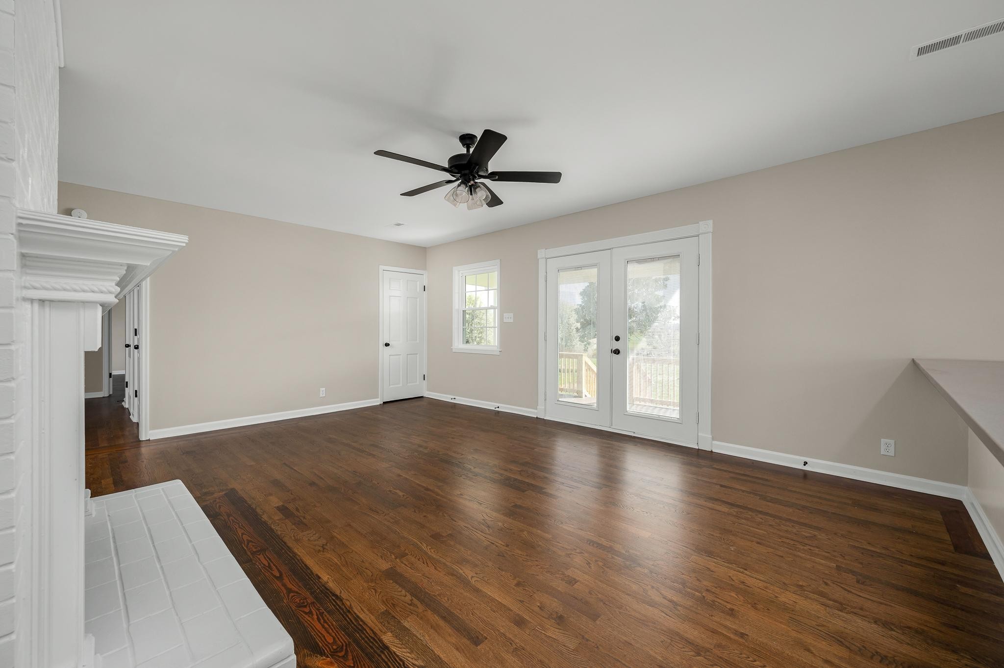2771 Kinneys Road Cedar Hill, TN 37032 - Photo 9 of 45 an empty room with wooden floor and windows