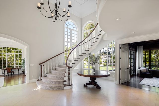 a view of entryway and hall with a living room