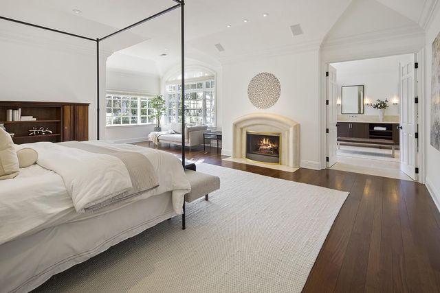 a spacious bedroom with a bed and a fireplace