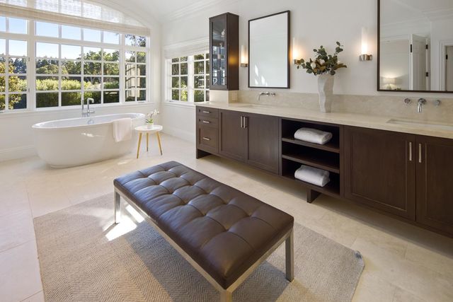 a living room with furniture and large windows