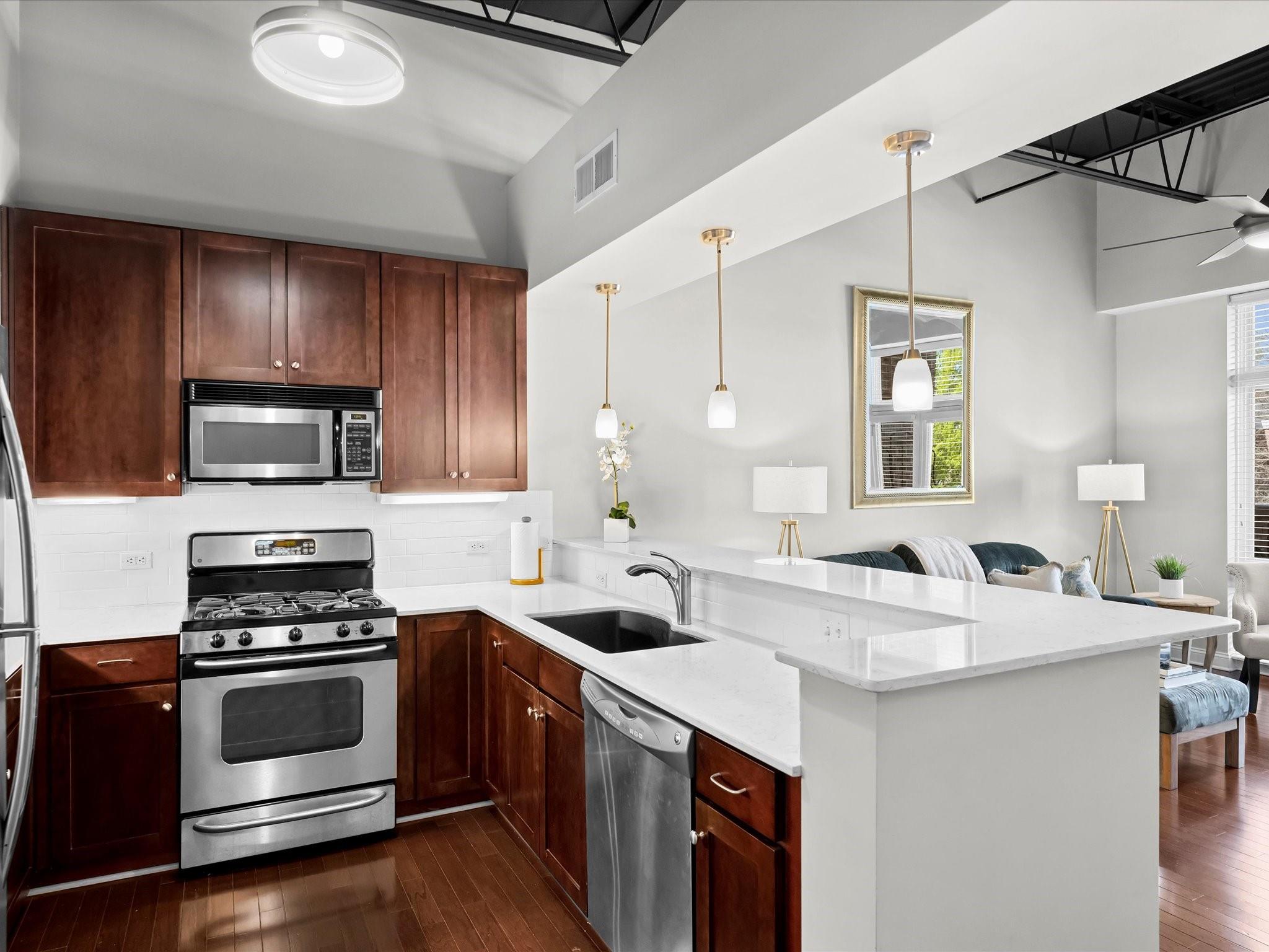 3920 Sharon Road, Unit 210 Charlotte, NC 28211 - Photo 7 of 34 a kitchen with stainless steel appliances a stove sink and microwave