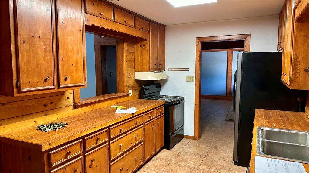 126 Garza Road Shady Shores, TX 76208 - Photo 4 of 19 a kitchen with stainless steel appliances granite countertop a refrigerator and a stove