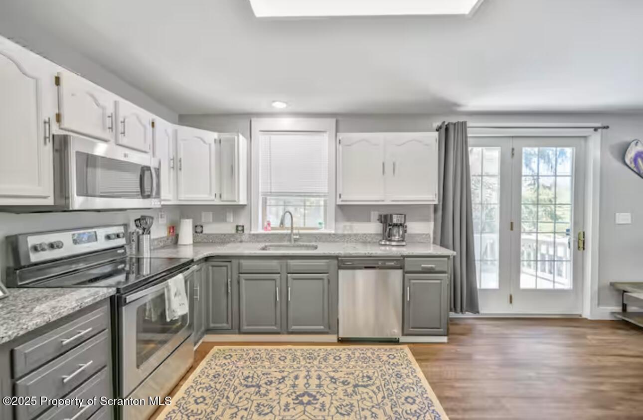 4562 Highway 374 Nicholson, PA 18446 - Photo 12 of 43 a kitchen with stainless steel appliances granite countertop a sink and cabinets