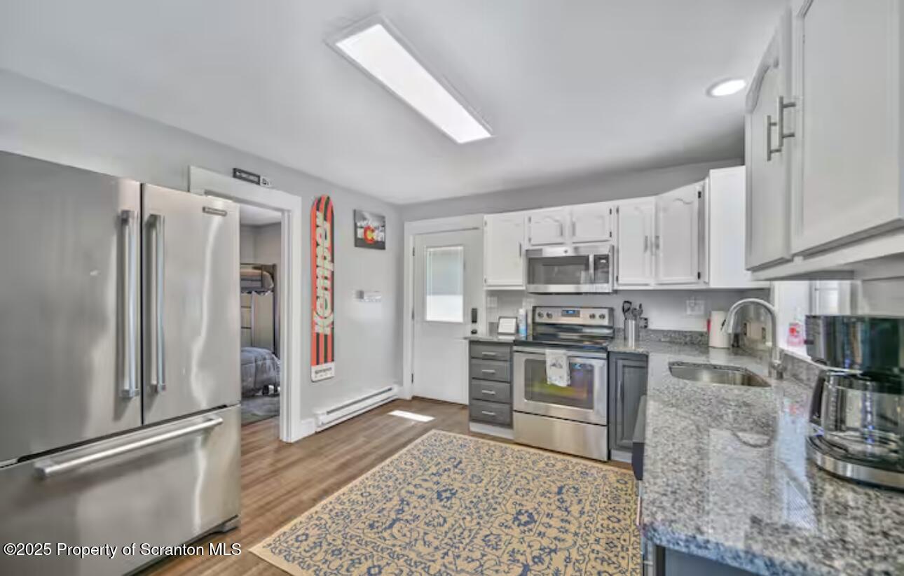 4562 Highway 374 Nicholson, PA 18446 - Photo 13 of 43 a kitchen with stainless steel appliances granite countertop a refrigerator sink and stove