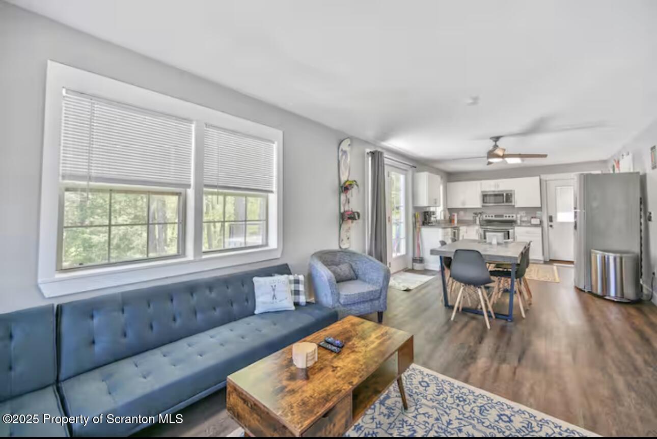 4562 Highway 374 Nicholson, PA 18446 - Photo 18 of 43 a living room with furniture and a wooden floor