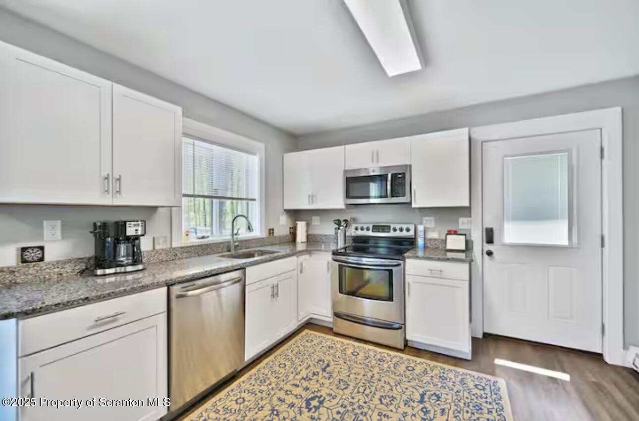 4562 Highway 374 Nicholson, PA 18446 - Photo 27 of 43 a kitchen with granite countertop appliances cabinets and a sink