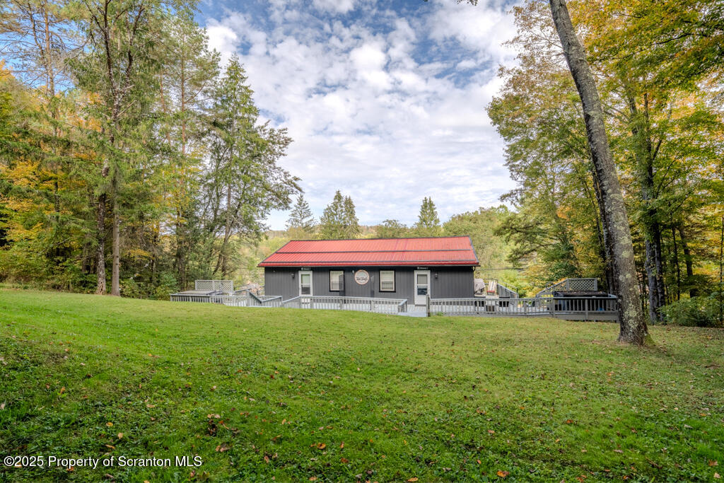 4562 Highway 374 Nicholson, PA 18446 - Photo 35 of 43 a view of a house with a yard table and chairs