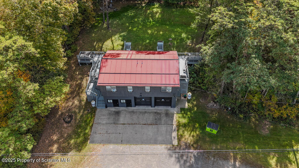 4562 Highway 374 Nicholson, PA 18446 - Photo 40 of 43 a view of a house with a small yard and large trees