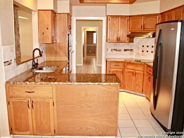 a kitchen with stainless steel appliances a refrigerator and a stove