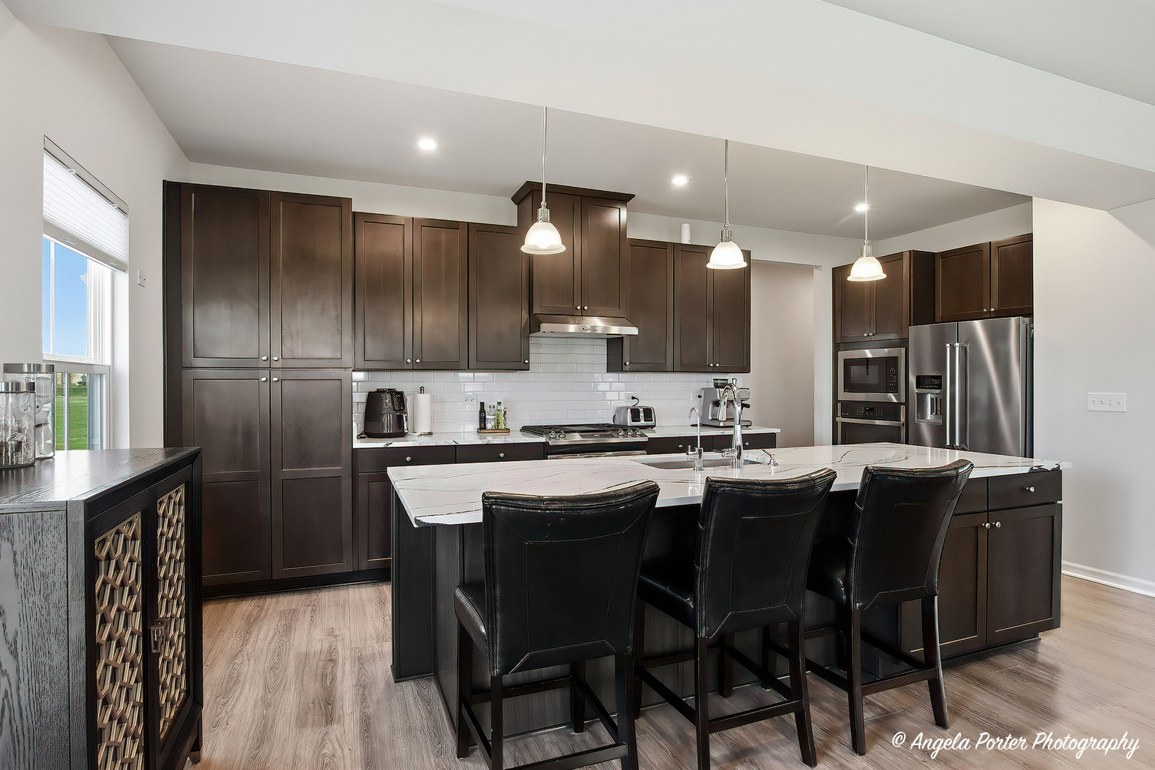 7443 Alexandra Lane Union, IL 60180 - Photo 11 of 39 a kitchen with kitchen island granite countertop wooden cabinets and refrigerator