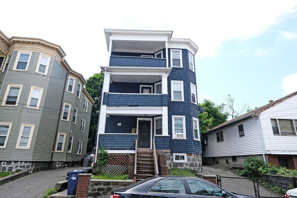a front view of a house with a garden