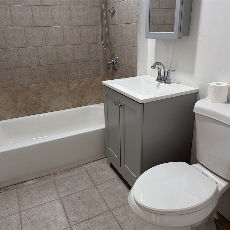 46 Theodore Street Boston, MA 02124 - Photo 14 of 32 a bathroom with a sink a toilet and bathtub
