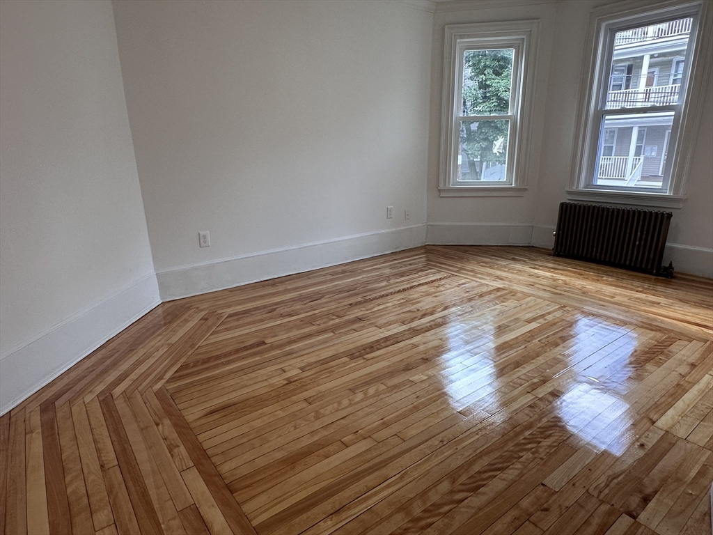 46 Theodore Street Boston, MA 02124 - Photo 16 of 32 a view of empty room with wooden floor and fan