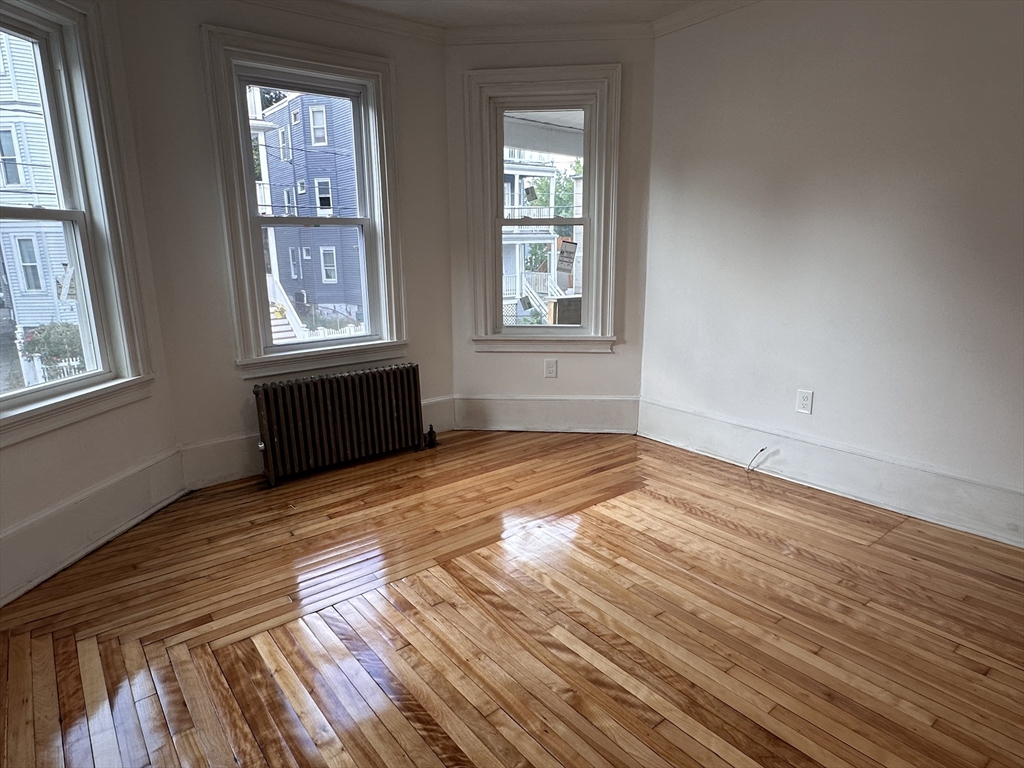 46 Theodore Street Boston, MA 02124 - Photo 17 of 32 a view of empty room with wooden floor and fan