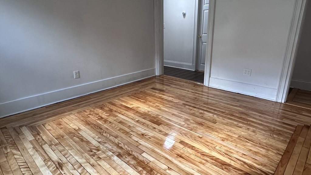 46 Theodore Street Boston, MA 02124 - Photo 21 of 32 a view of empty room with wooden floor