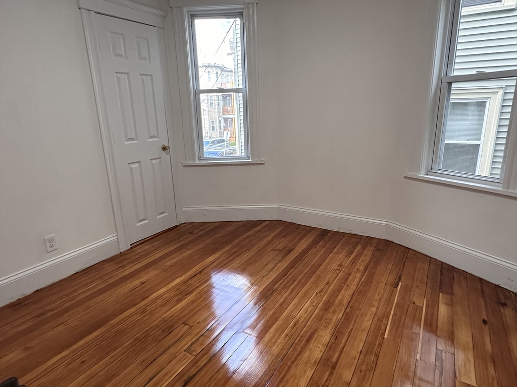 46 Theodore Street Boston, MA 02124 - Photo 23 of 32 a view of a room with wooden floor and window