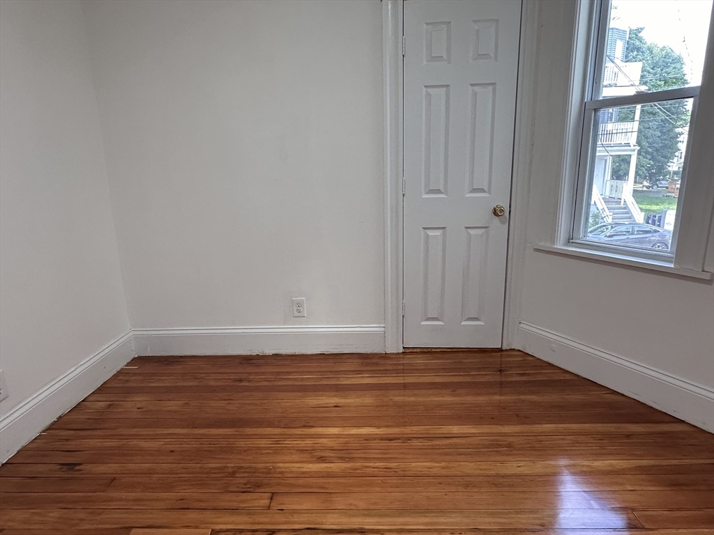 46 Theodore Street Boston, MA 02124 - Photo 24 of 32 a view of a room with wooden floor and window