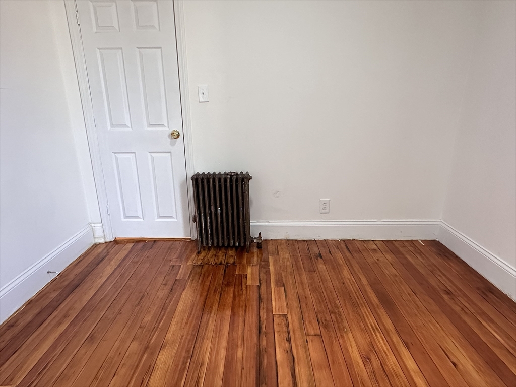 46 Theodore Street Boston, MA 02124 - Photo 25 of 32 a view of empty room with wooden floor and fan