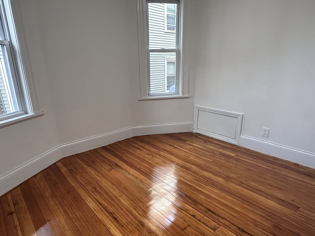 46 Theodore Street Boston, MA 02124 - Photo 26 of 32 a view of empty room with wooden floor and fan